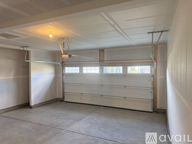 A spacious garage with a white ceiling and a large window.
