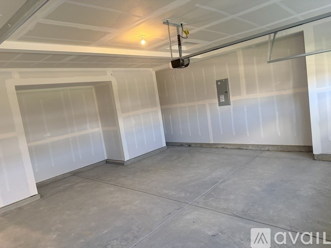 A spacious room with a white ceiling and a grey floor.