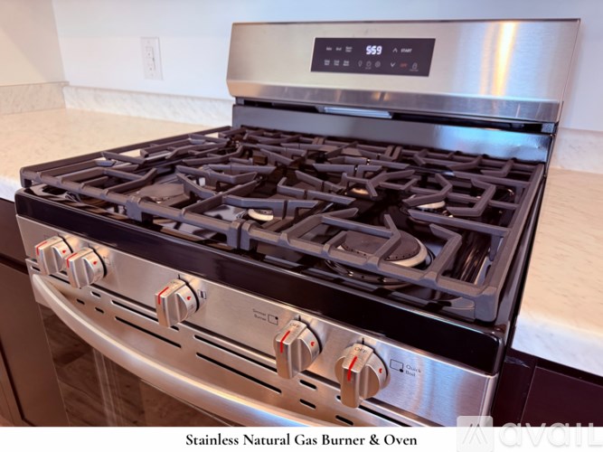 A stainless steel microwave oven with a digital display showing the time as 8:00.