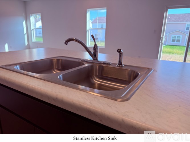 A spacious kitchen with a sink and a window overlooking a beach.
