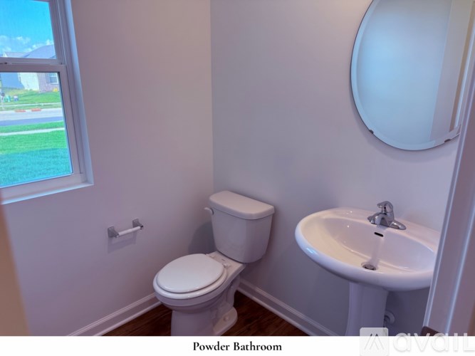 A room with a carpeted floor and a staircase leading to another room.
