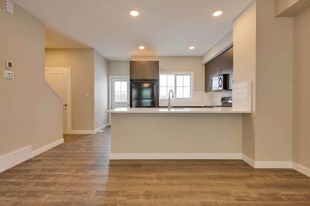 A kitchen area with a countertop and cabinets.