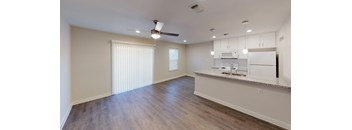 Open Kitchen and Living area with granite counter tops and pendant accent lighting