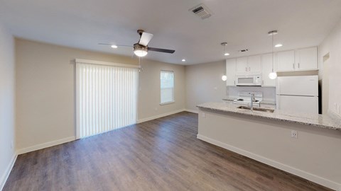 Open Kitchen and Living area with granite counter tops and pendant accent lighting