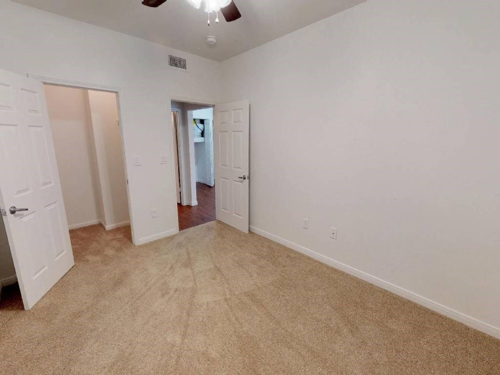 A room with a carpeted floor and white walls.