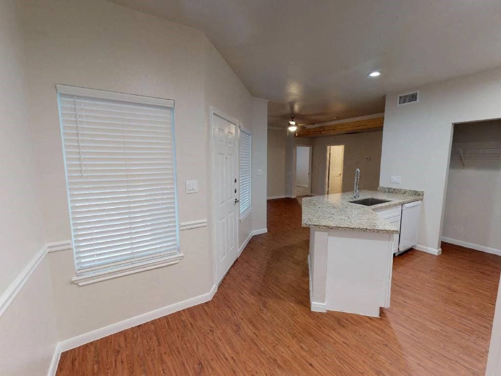 A kitchen area with a sink and cabinets.
