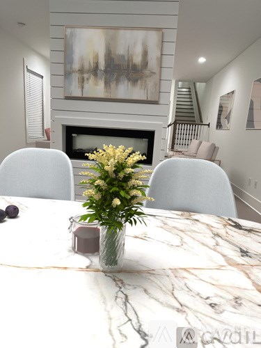 A dining table with a vase of flowers and a candle on it.