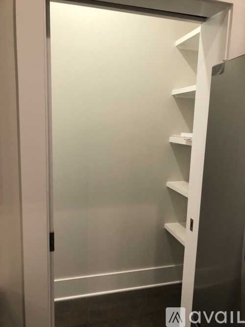 A white shelving unit with a glass door.