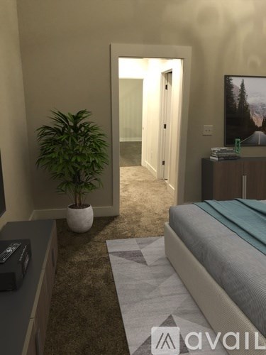 A bedroom with a bed, a plant, and a cabinet.