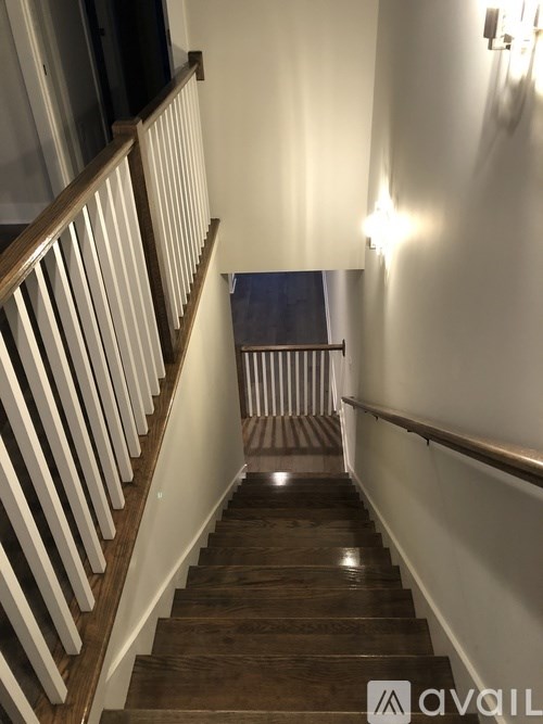 A staircase with wooden steps and a metal railing.