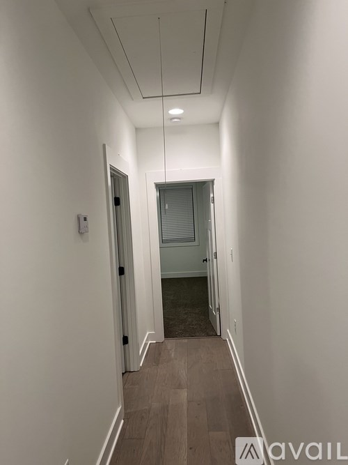 A long hallway with a door at the end.