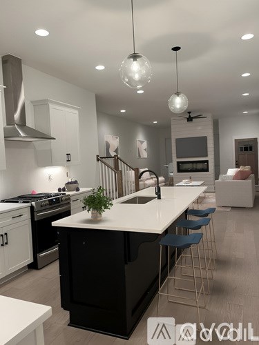A modern kitchen with a black island and white countertops.