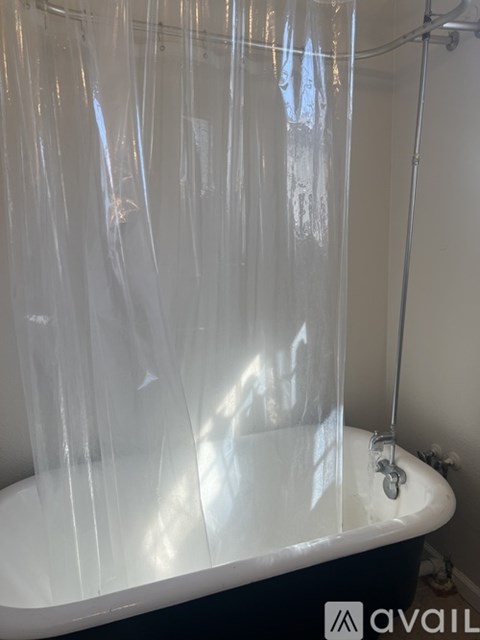 A bathroom with a tub covered in plastic.