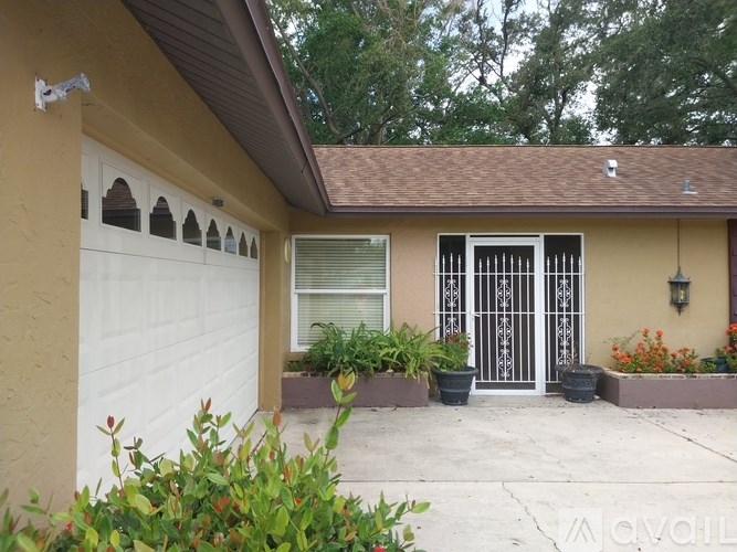 A house with a white garage door and a brown roof.