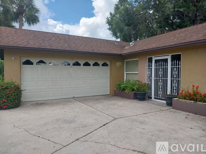 A house with a white garage door and a brown roof.