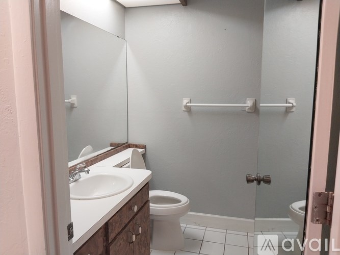 A bathroom with a toilet, sink, and shower.
