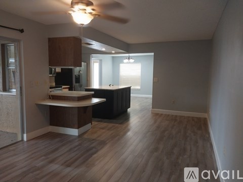 A kitchen area with a counter and a fan.