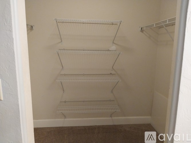 Empty white shelves in a small room.