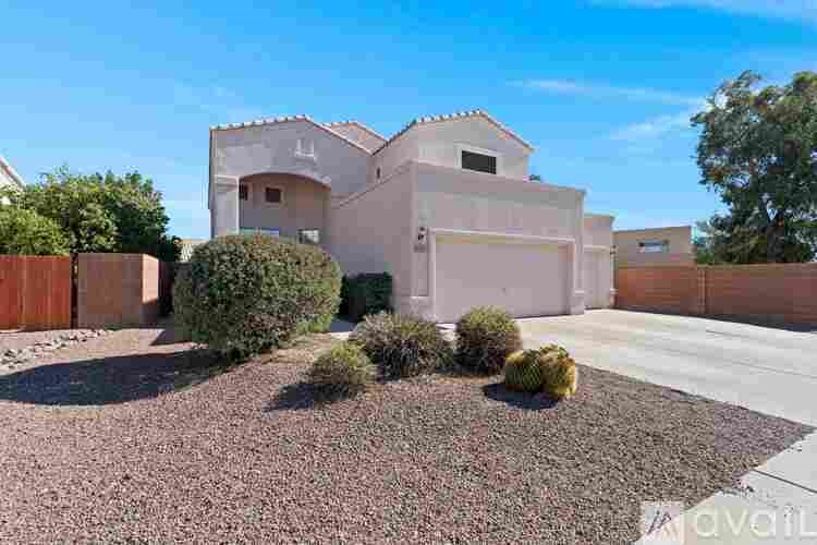 A house with a brown fence and a gravel driveway.
