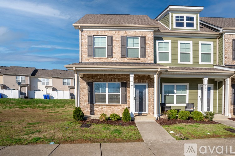 A house with a front yard and a driveway.