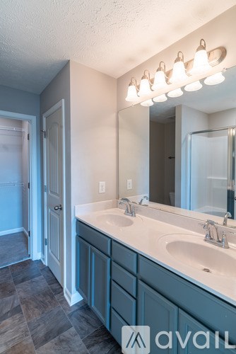A bathroom with a large mirror and two sinks.