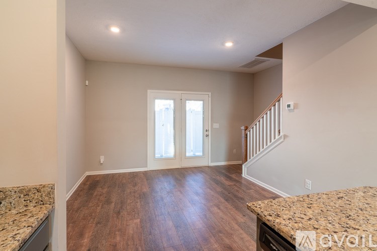 A room with wooden floors and a staircase.
