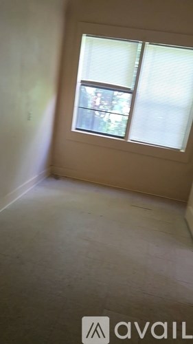 A room with a window and a wall.