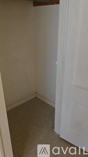 A room with a white door and a white wall.