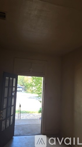 A view of a street through a doorway.