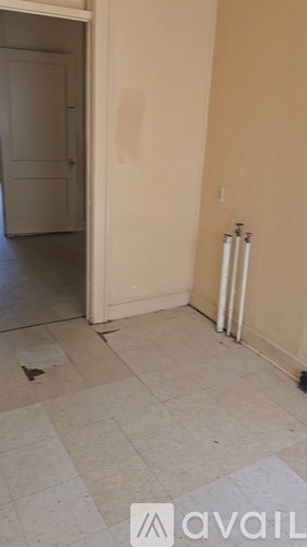 A room with a white door and a radiator on the wall.