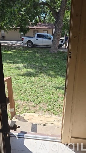 A white pickup truck is parked in a driveway.