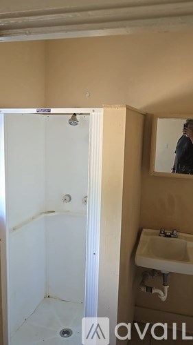 A bathroom with a sink and a shower.