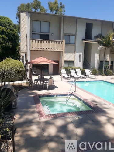 A pool and patio area in front of a building.