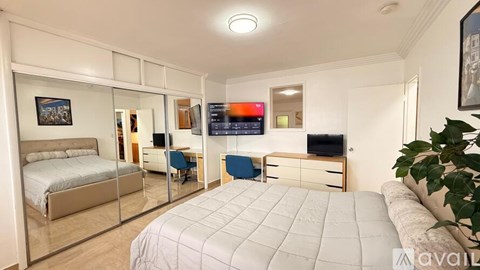 A living room with a flat screen TV mounted on the wall.