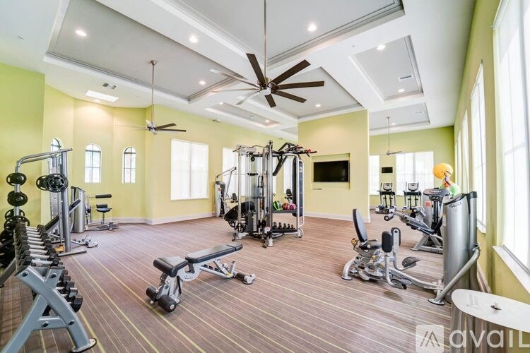A spacious home gym with a variety of exercise equipment.