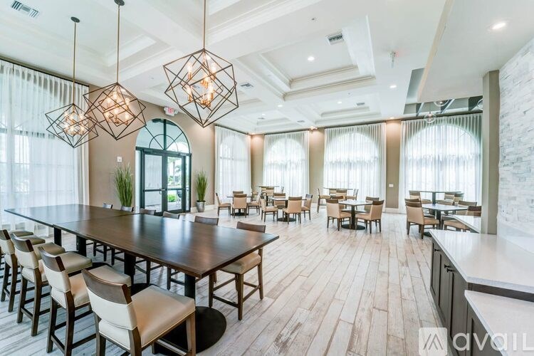 A modern dining room with a long table and chairs.
