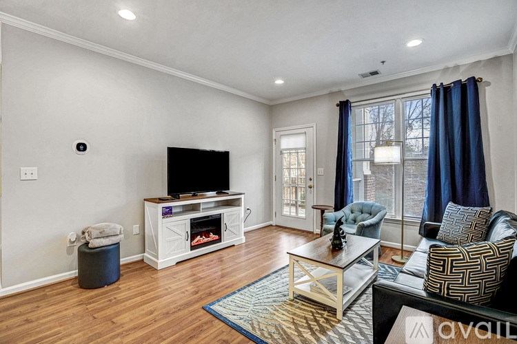 A living room with a television, a fireplace, and a couch.