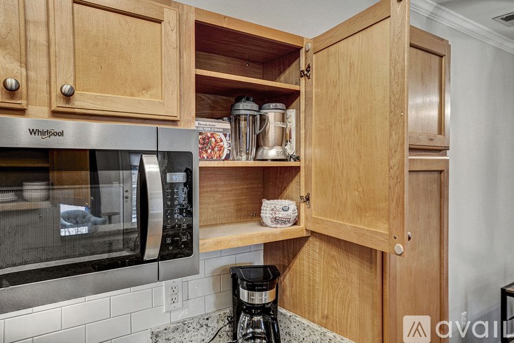 A kitchen with wooden cabinets and a stainless steel oven.