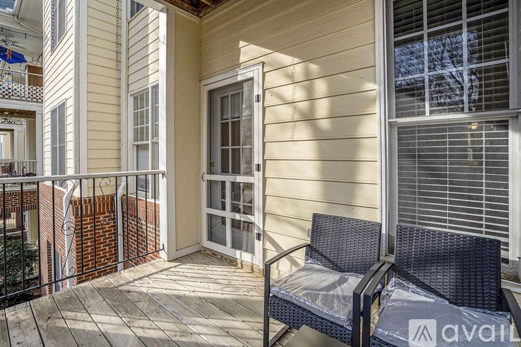 A balcony with a chair and a table is shown.