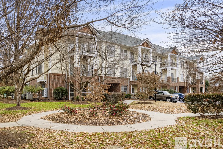 A large apartment complex with a courtyard and trees.