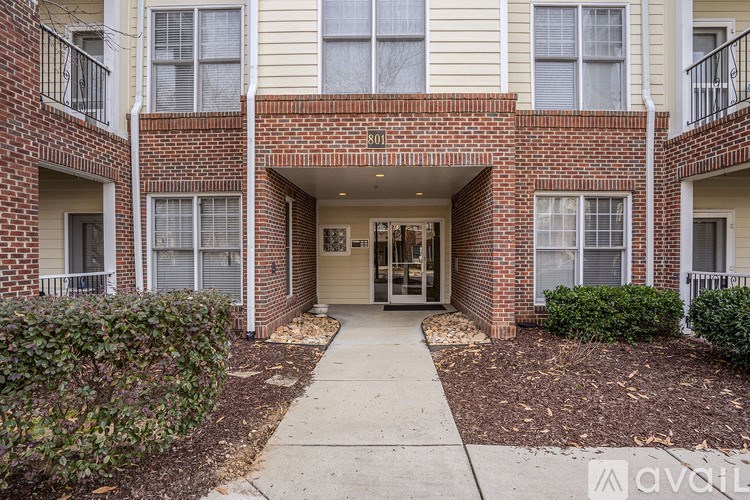 The image shows a brick building with a white door and windows.