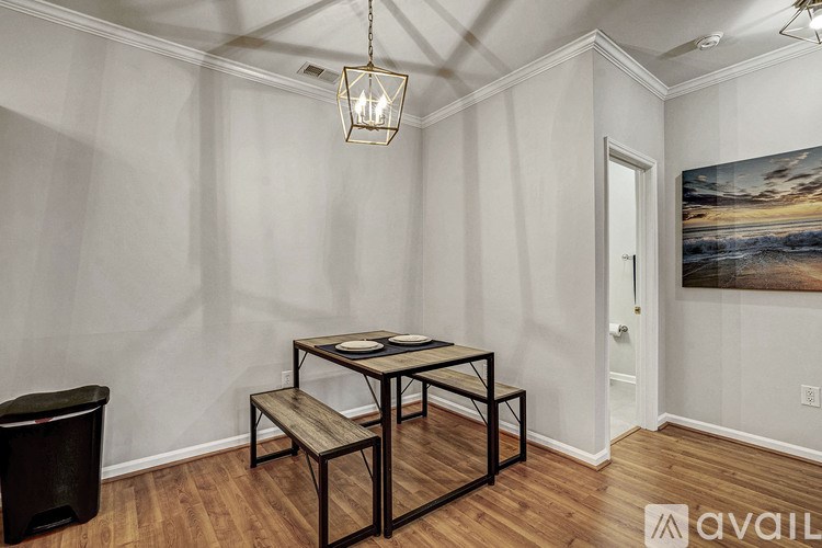 A room with a dining table and chairs.