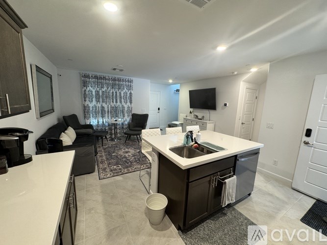 A kitchen with a white countertop and a black and white rug.