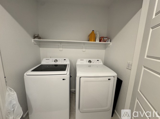 A small laundry room with a washer and dryer.