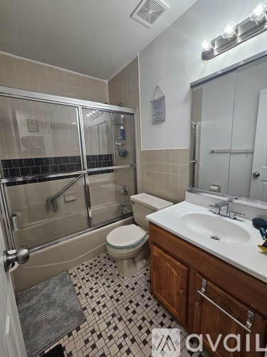A bathroom with a toilet, sink, and shower.