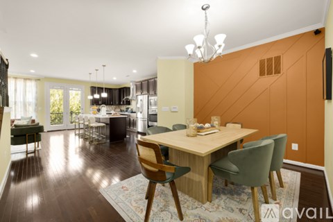 A modern dining room with a wooden table and chairs.