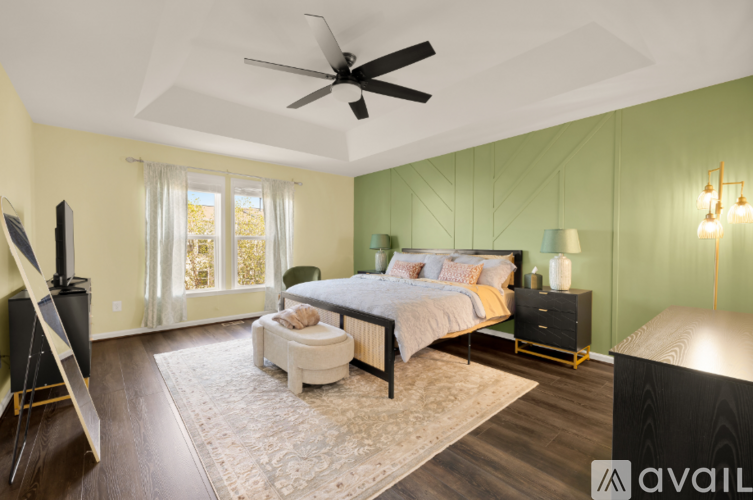 A bedroom with a bed, nightstand, and chair.