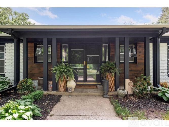 A house with a porch and a garden in front.