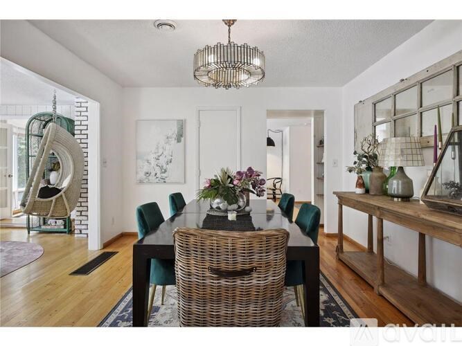 A dining room with a wooden table and chairs.