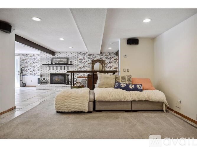 A modern living room with a fireplace and a large couch.